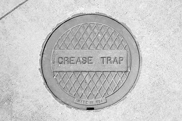 signs that your grease trap needs pumping include slow drainage and a foul odor